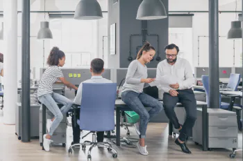 Bürobeleuchtung Menschen im Büro unter großen Lampenschirmen